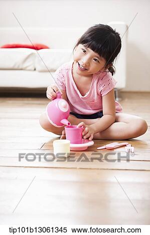 Stock Photography - kids playing with toy dishes. Fotosearch