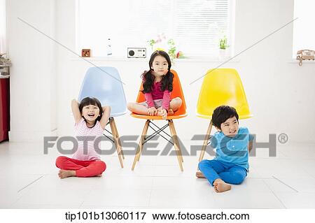 kids sitting next to chairs View Large Photo Image Stock Photo - kids sitting next to chairs. Fotosearch