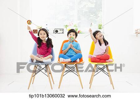 Stock Image - kids sitting on chairs. Fotosearch