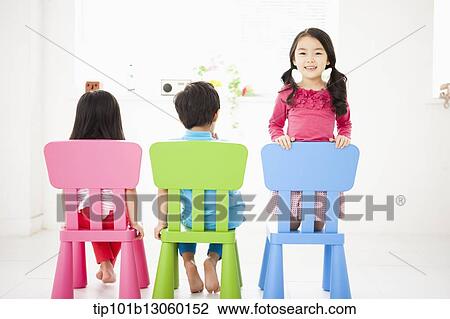 kids sitting on chairs View Large Photo Image Stock Image - kids sitting on chairs. Fotosearch