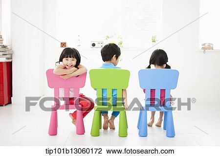 Stock Image - kids sitting on chairs. Fotosearch