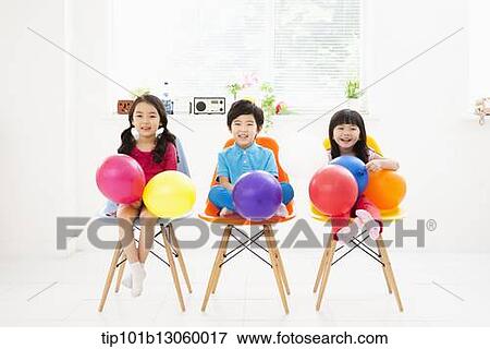 Stock Photo - kids sitting on chairs. Fotosearch