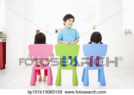Stock Photo - kids sitting on chairs. Fotosearch