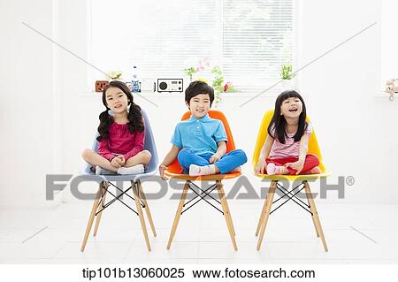 Stock Photography - kids sitting on chairs. Fotosearch
