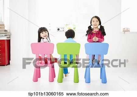 Stock Photography - kids sitting on chairs. Fotosearch