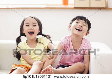 Stock Image - kids sitting on couch. Fotosearch