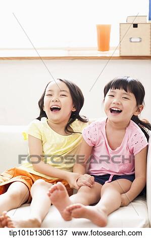 Stock Photo - kids sitting on couch. Fotosearch