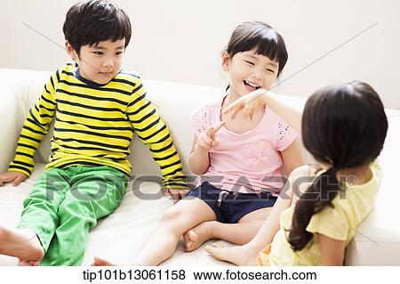 kids sitting on couch View Large Photo Image Stock Photo - kids sitting on couch. Fotosearch