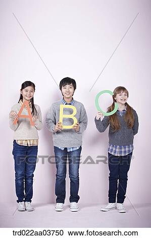 kids standing and holding alphabets View Large Photo Image Stock Image - kids standing and holding alphabets. Fotosearch