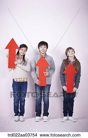 kids standing and holding red arrows View Large Photo Image Picture - kids standing and holding red arrows. Fotosearch