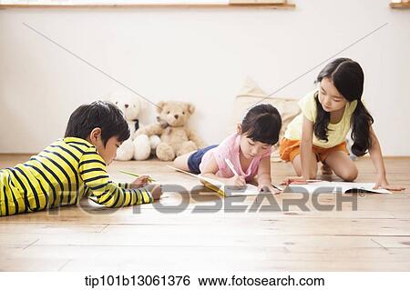 Stock Photograph - kids writing into a book. Fotosearch
