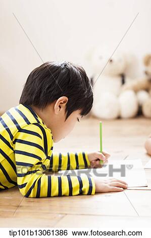 Stock Photograph - kids writing into a book. Fotosearch
