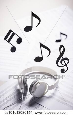 musical notes and headset on musical papers View Large Photo Image Picture - musical notes and headset on musical papers . Fotosearch