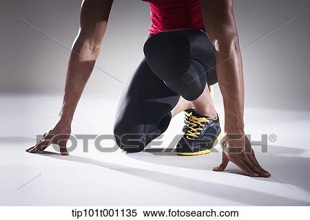 Stock Photography - partial close up shot of a runner in starting position. Fotosearch