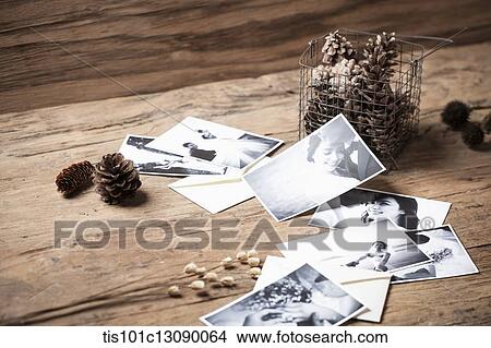 Picture - pictures and a pine cones on wooden desk. Fotosearch