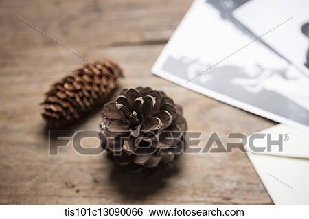 pictures and a pine cones on wooden desk View Large Photo Image Stock Photograph - pictures and a pine cones on wooden desk. Fotosearch