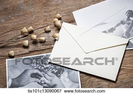 pictures and an envelop on wooden desk View Large Photo Image Stock Photo - pictures and an envelop on wooden desk. Fotosearch