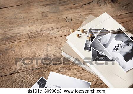 pictures and books on wooden surface View Large Photo Image Stock Image - pictures and books on wooden surface. Fotosearch