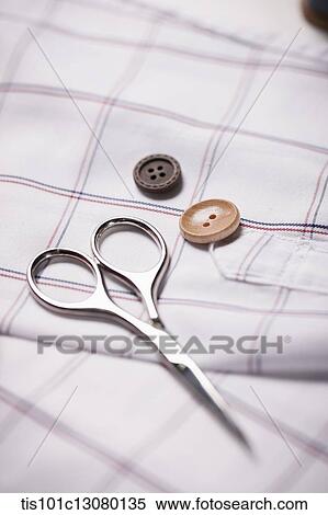 scissor and buttons on a shirt View Large Photo Image Stock Photography - scissor and buttons on a shirt. Fotosearch