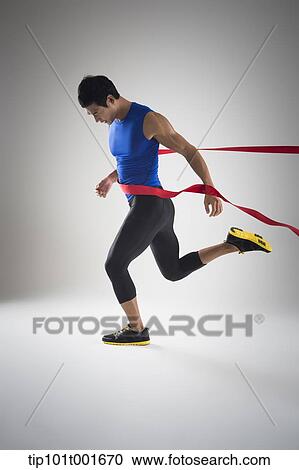 side shot of a fit man in blue shirt running to a finishing line View Large Photo Image Stock Image - side shot of a fit man in blue shirt running to a finishing line. Fotosearch