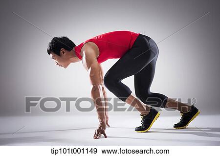 Stock Photo - side shot of a runner in starting position. Fotosearch