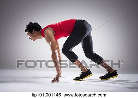 Stock Photograph - side shot of a runner in starting position. Fotosearch