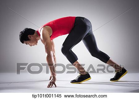 Stock Photography - side shot of a runner in starting position. Fotosearch