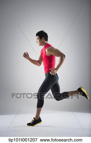 Stock Photo - side shot of a runner running. Fotosearch