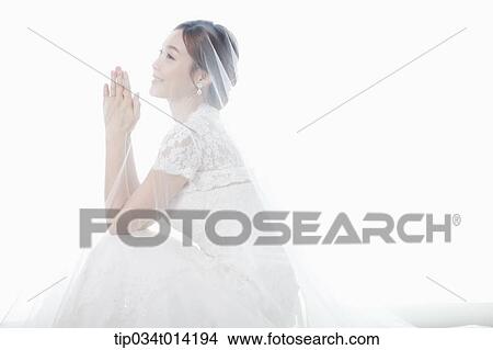 Picture - side shot of a woman in wedding dress. Fotosearch
