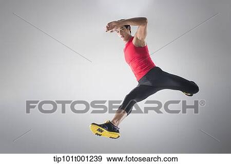 Stock Photo - side shot of an athlete jumping . Fotosearch