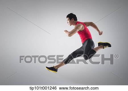 Stock Photograph - side shot of an athlete jumping . Fotosearch