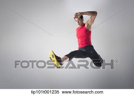 Stock Photography - side shot of an athlete jumping . Fotosearch