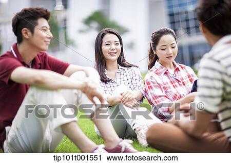 students sitting on grass having a conversation View Large Photo Image Stock Image - students sitting on grass having a conversation. Fotosearch