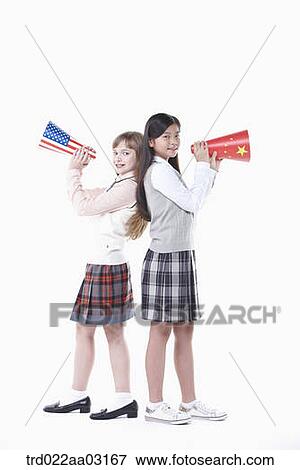 Stock Photo - two girls dressed as students with paper megaphones. Fotosearch