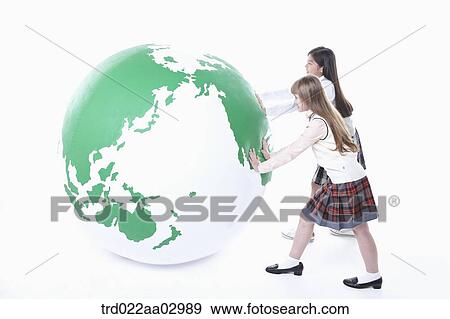 two girls pushing a globe View Large Photo Image Stock Photo - two girls pushing a globe. Fotosearch