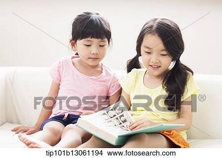 two girls reading a book View Large Photo Image Picture - two girls reading a book. Fotosearch