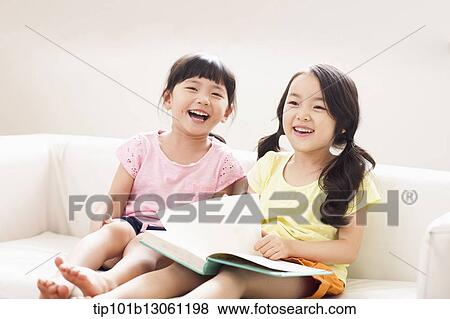 two girls reading a book View Large Photo Image Stock Photo - two girls reading a book. Fotosearch