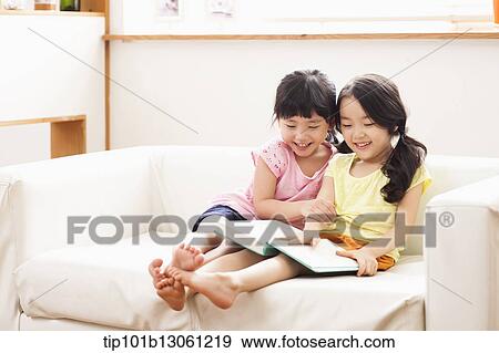 two girls reading a book View Large Photo Image Stock Photo - two girls reading a book. Fotosearch