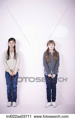 Stock Image - two girls standing next to each other. Fotosearch