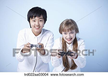 two kids playing a video game View Large Photo Image Picture - two kids playing a video game. Fotosearch
