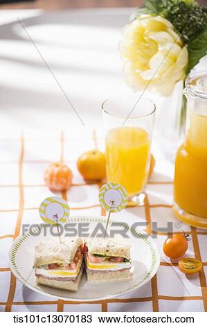 two sandwiches next to a glass of juice View Large Photo Image Stock Image - two sandwiches next to a glass of juice. Fotosearch