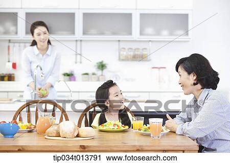 two women and a kid in the kitchen View Large Photo Image Stock Image - two women and a kid in the kitchen. Fotosearch