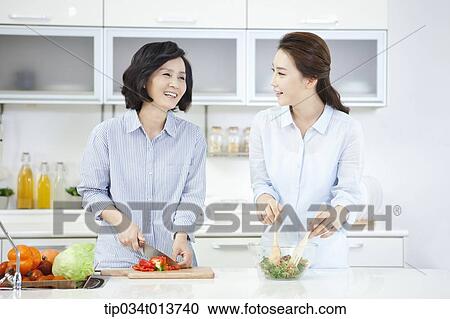 two women cooking in the kitchen View Large Photo Image Stock Image - two women cooking in the kitchen. Fotosearch