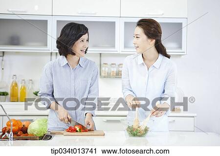 two women cooking in the kitchen View Large Photo Image Stock Image - two women cooking in the kitchen. Fotosearch