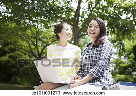 Stock Image - university students walking in the campus talking . Fotosearch