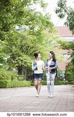 Stock Photo - university students walking in the campus talking . Fotosearch