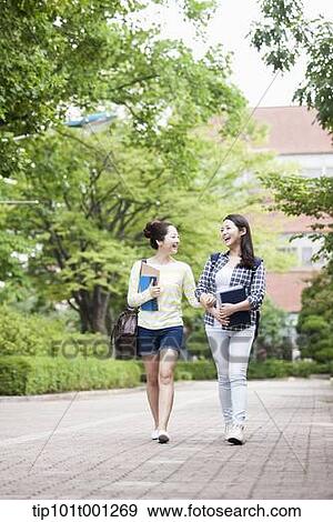 Stock Photo - university students walking in the campus talking . Fotosearch