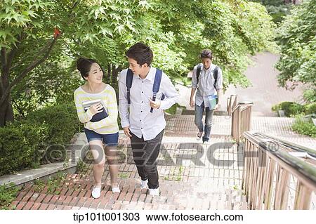 Stock Image - university students walking up the stairs together in the campus . Fotosearch