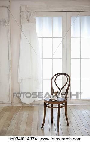 Picture - wedding heels on wooden chair. Fotosearch