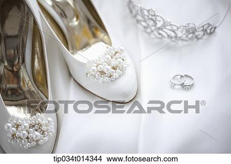 wedding rings and heels on wedding dress View Large Photo Image Picture - wedding rings and heels on wedding dress. Fotosearch